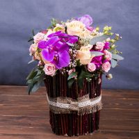 phalaenopsis orchids, spray roses, cream rose, bouvardia, purple carnations, decorative branches, packaging, ribbon